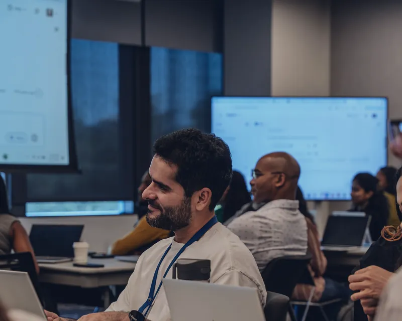 Participants on laptops during a business training session